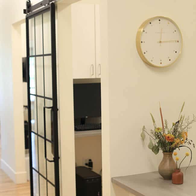 Inside the office with a gold clock on the wall