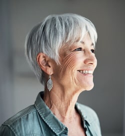 A happy elderly woman looking to the side and smiling